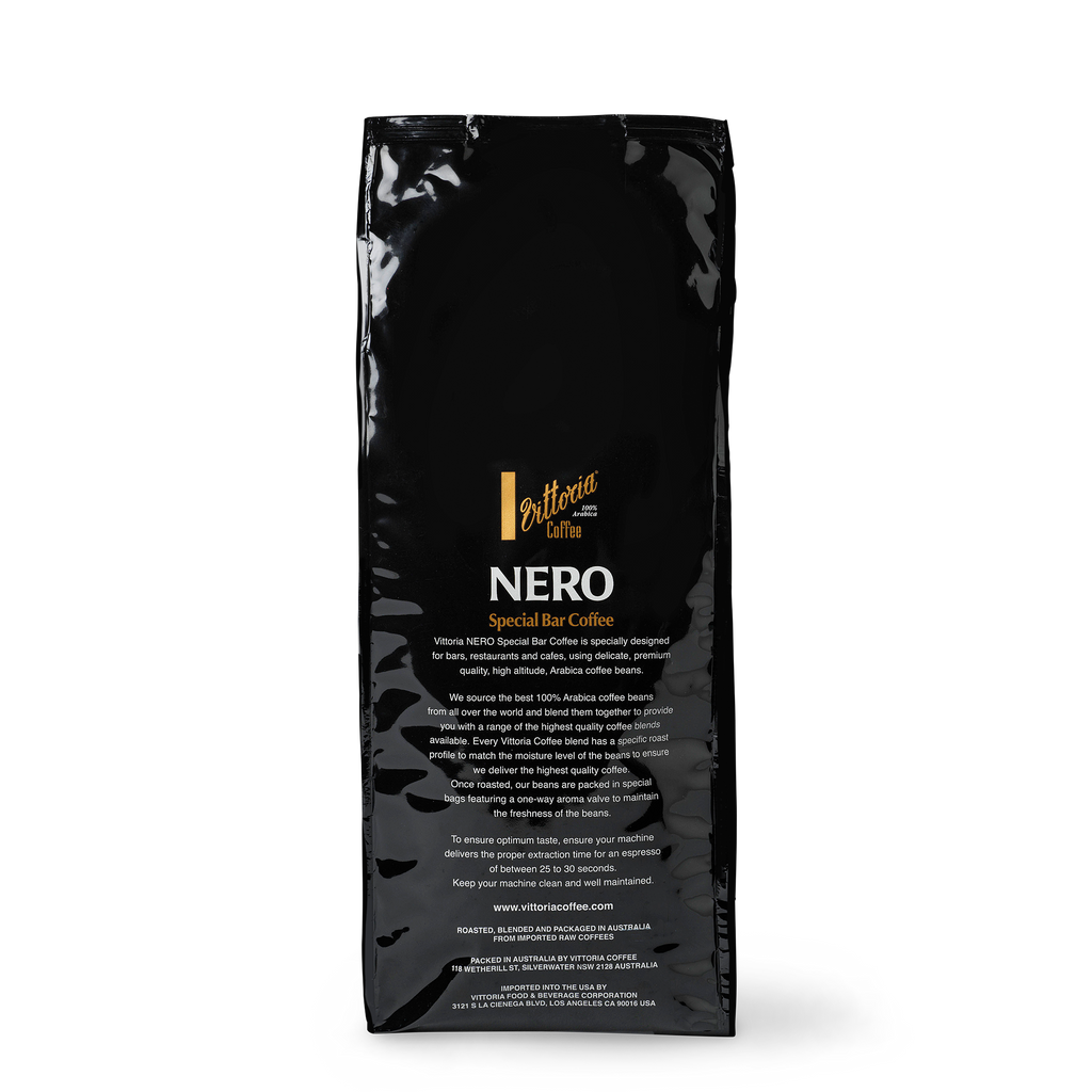 Nero Special Bar 1 kg dark‑roast coffee beans in a black bag with label, rear shot with description